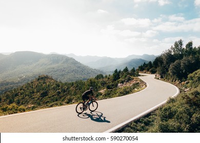 A Cyclist On A Mountain Road