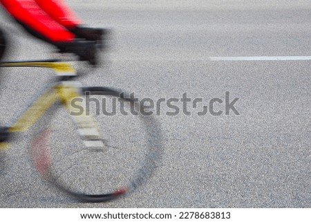 Cyclist on the road with racing bike - blurred concept with copy space