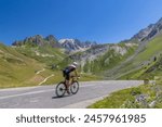 cyclist on route des Grandes Alpes near Col du Galibier, Hautes-Alpes, France