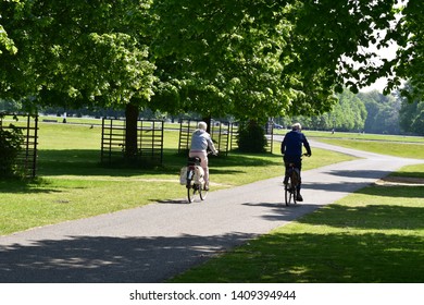 Cyclist In The Park. A Couple Riding Bikes In The Park. Cycling In The UK