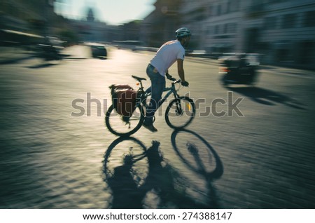 Cyclist passes by in a blur along the traditional cobblestone streets of Rome Italy
