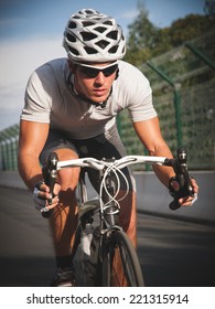 Cyclist Portrait In Action On The Road In A Sunny Day.