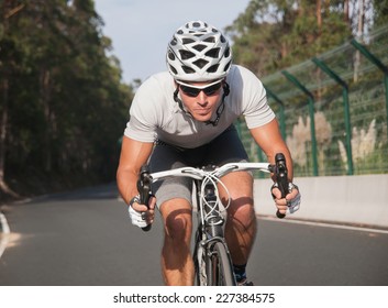 Cyclist Portrait In Action On The Road In A Sunny Day.