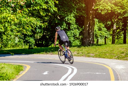 Cyclist Ride On The Bike Path In The City Park 