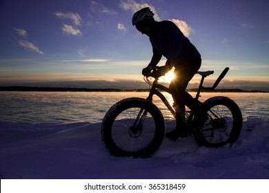 Cyclist Rides Fat Tire Bike In Winter At Sunset