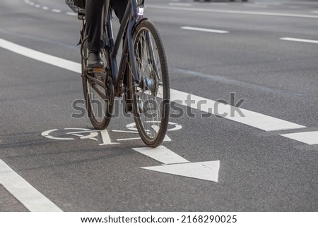 cyclist rides on bike lane via bicycle pictogram