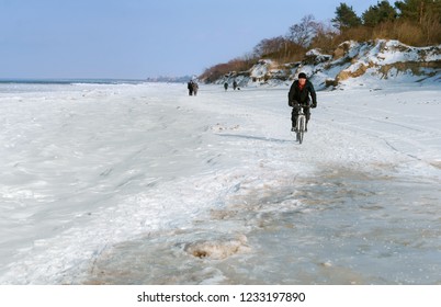 A Cyclist Rides Through The Snow. To Ride A Bike In The Winter. Kaliningrad Region, Russia, 04 March 2018.