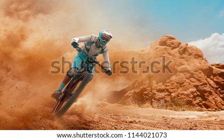Cyclist riding a bicycle. Downhill.