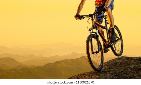 Cyclist Riding the Bike in the Beautiful Mountains Down the Rock on the Sunset Sky Background. Extreme Sport and Enduro Biking Concept. - Shutterstock ID 1130921870