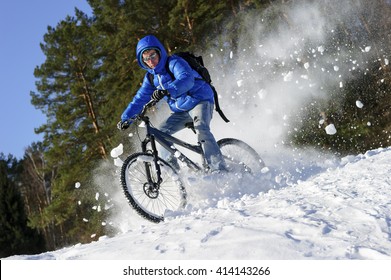 Cyclist Riding Bike, Extreme Winter Cycling Near Snowbanks Of Snowy Mountain Slope, Cross Country Biking Near Forest In Cool Sunny Day 