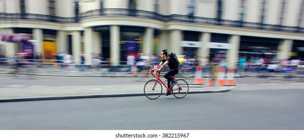 Cyclist Riding Bike Fast Through City. Speed Blur