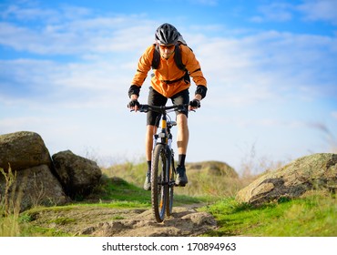 Cyclist Riding The Bike On The Beautiful Spring Mountain Trail