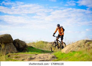 Cyclist Riding The Bike On The Beautiful Spring Mountain Trail