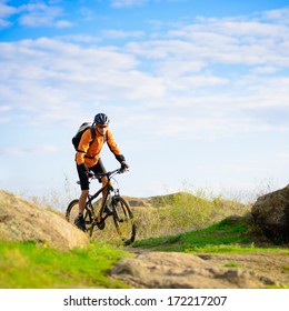 Cyclist Riding The Bike On The Beautiful Spring Mountain Trail