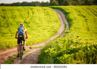 Cyclist Riding The Bike On The Beautiful Spring Mountain Trail
