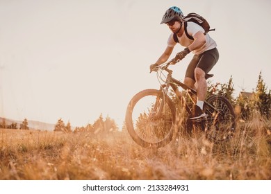 Cyclist Riding the Bike on the Trail in the Forest. Man cycling on enduro trail track. Sport fitness motivation and inspiration. Extreme Sport Concept. Selective focus. High-quality photo