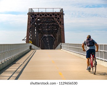 Cyclist Riding Bike On Urban Path Across Big Four Bridge In The City Of Louisville, Kentucky