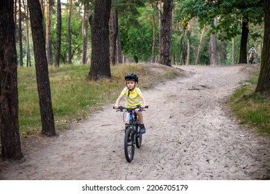 Cyclist Riding Down The Sandy Hill On The Offroad Trail.