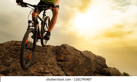 Cyclist Riding the Mountain Bike Down the Rock on the Sunset Sky Background. Extreme Sport and Enduro Biking Concept. - Shutterstock ID 1181790487
