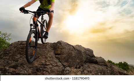 Cyclist Riding the Mountain Bike Down the Rock on the Sunset Sky Background. Extreme Sport and Enduro Biking Concept. - Shutterstock ID 1181790493