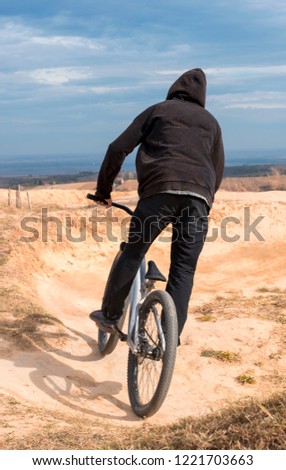 Cyclist riding mountain bike on a mountain bike track.  
