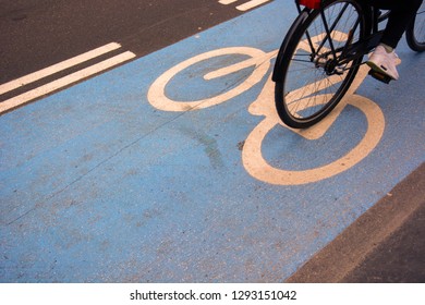 Cyclist Riding On Blue Bicycle Lane Top Shot Close Up Of Rear Of Bicycle In Copenhagen With Bicycle Graphic On Floor