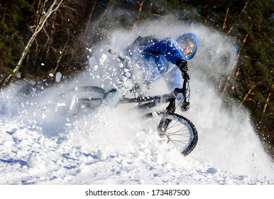 Cyclist Riding On A Mountain Bike In The Snow In The Winter Forest