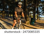 A cyclist riding through a serene pine forest, bathed in the warm, golden glow of the setting sun.

