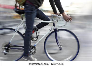 Cyclist In Traffic On The City Roadway Motion Blur