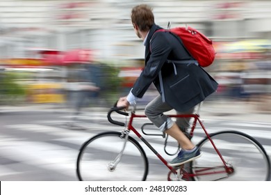 Cyclist In Traffic On The City Roadway  Motion Blur 