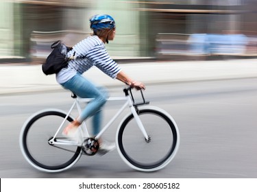 Cyclist In Traffic On The City Roadway  Motion Blur