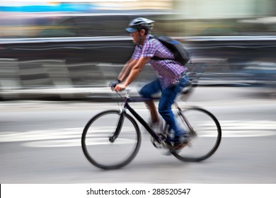 Cyclist In Traffic On The City Roadway  Motion Blur