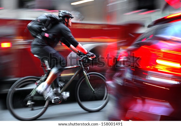 cyclist in\
traffic on the city roadway motion\
blur