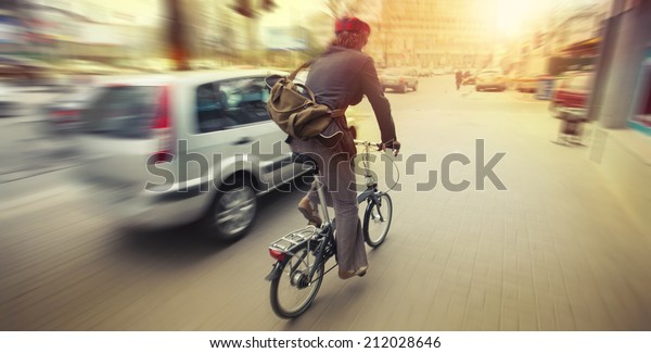 cyclist in\
traffic on the city roadway motion\
blur