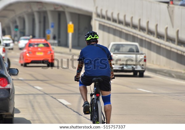 cyclist in traffic on the\
city roadway 