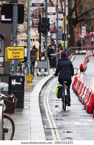 Cyclist using temporary cycle lane in rain in London
UK December 2020