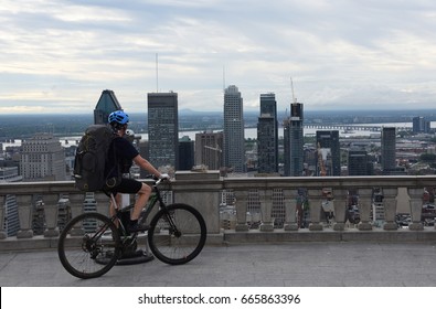 Cyclist Watching Montreal Downtown From Mount Royal Park