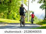 Cyclists ride on the bike path in the city Park