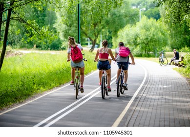 
    Cyclists Ride On The Bike Path In The City Park 