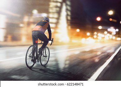 Cyclists Ride Through Lighted City