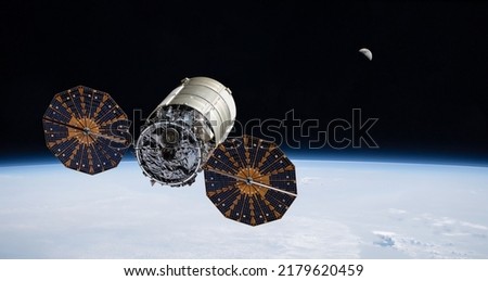 Cygnus spacecraft flight in space. Cygnus on orbit of Earth. Sci-fi wallpaper. Cargo expedition of Antares to ISS space station. Spaceship with astronauts. Elements of this image furnished by NASA