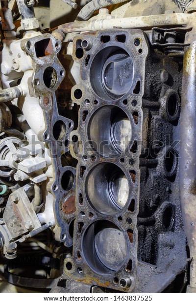 The cylinder block of the four-cylinder engine.
Disassembled motor vehicle for repair. Parts in engine oil. Car
engine repair in the
service.
