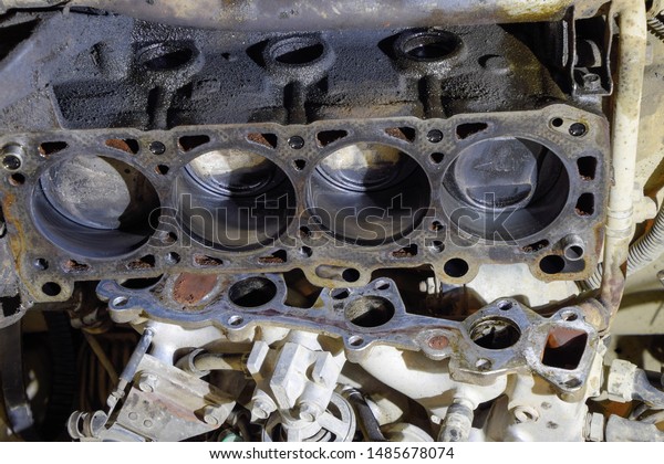 The cylinder block of the four-cylinder engine.\
Disassembled motor vehicle for repair. Parts in engine oil. Car\
engine repair in the\
service.