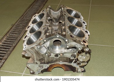 The Cylinder Block Of A Six-cylinder V-shaped Internal Combustion Engine Lies On The Floor In An Auto Repair Shop