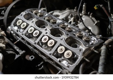 Cylinder head of a car engine. Sixteen valves. Repairing car. Auto service.