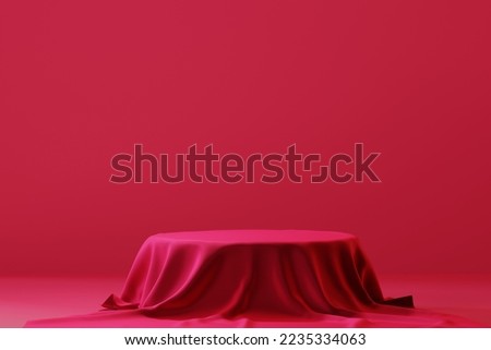 Cylinder podium covered with red cloth on viva magenta background. Premium empty fabric pedestal for product display. 
