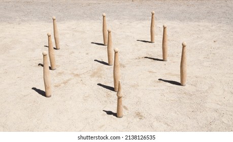 Cylindrical Wooden Skittles Placed To Play The Pass On Land.