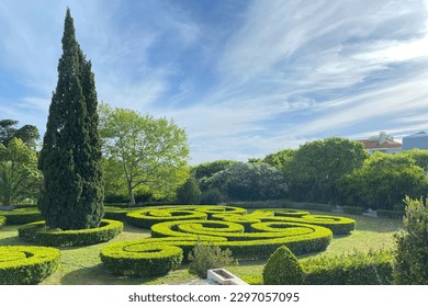 Cypress and topiary bushes in green park on a sunny day, Lisbon garden - Shutterstock ID 2297057095