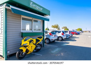 Cyprus, Larnaca Airport. 05.11.2021 Yellow motorcycle parked at the Europcar car rental office