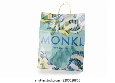 Cyprus, Paphos - SEPTEMBER 08, 2022: Colorful Branded Paper Bag Of Monki Swedish Womens Clothing Shop, Part Of HM Group. Over White Background.